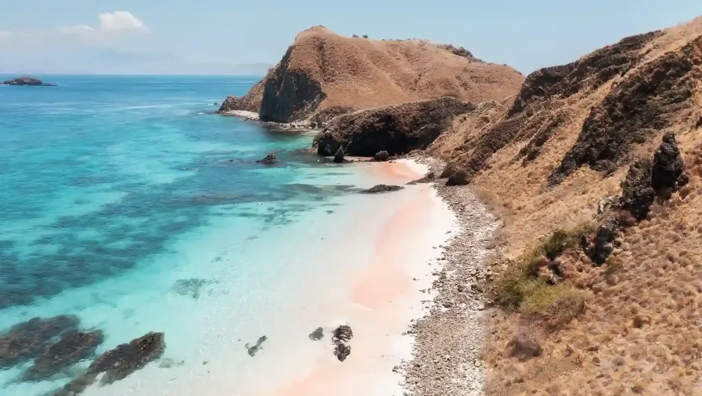 The blush sand and headland of Pink Beach, Komodo