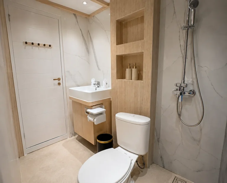Marble ensuite bathroom with rain shower in a LASHA Deluxe cabin
