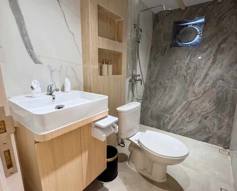 Marble ensuite bathroom with rain shower in a LASHA Grand Deluxe cabin