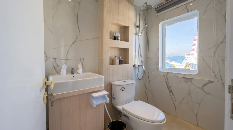 Marble ensuite bathroom with rain shower in a LASHA Junior Suite