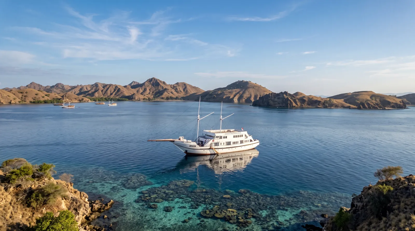 LASHA anchored over a coral bay in Komodo