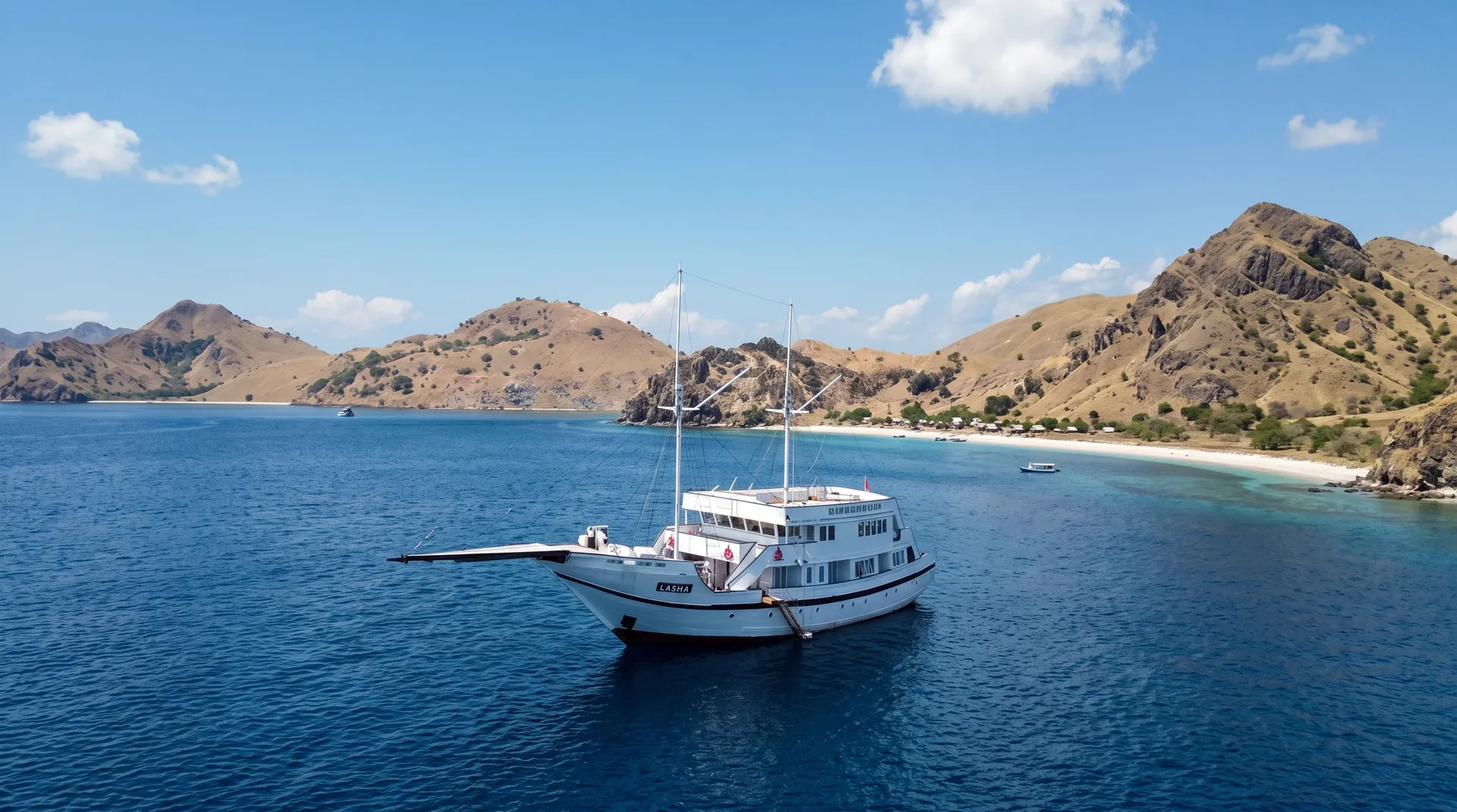 LASHA phinisi at anchor off a Komodo beach bay &mdash; photo from the official site lashacruise.com